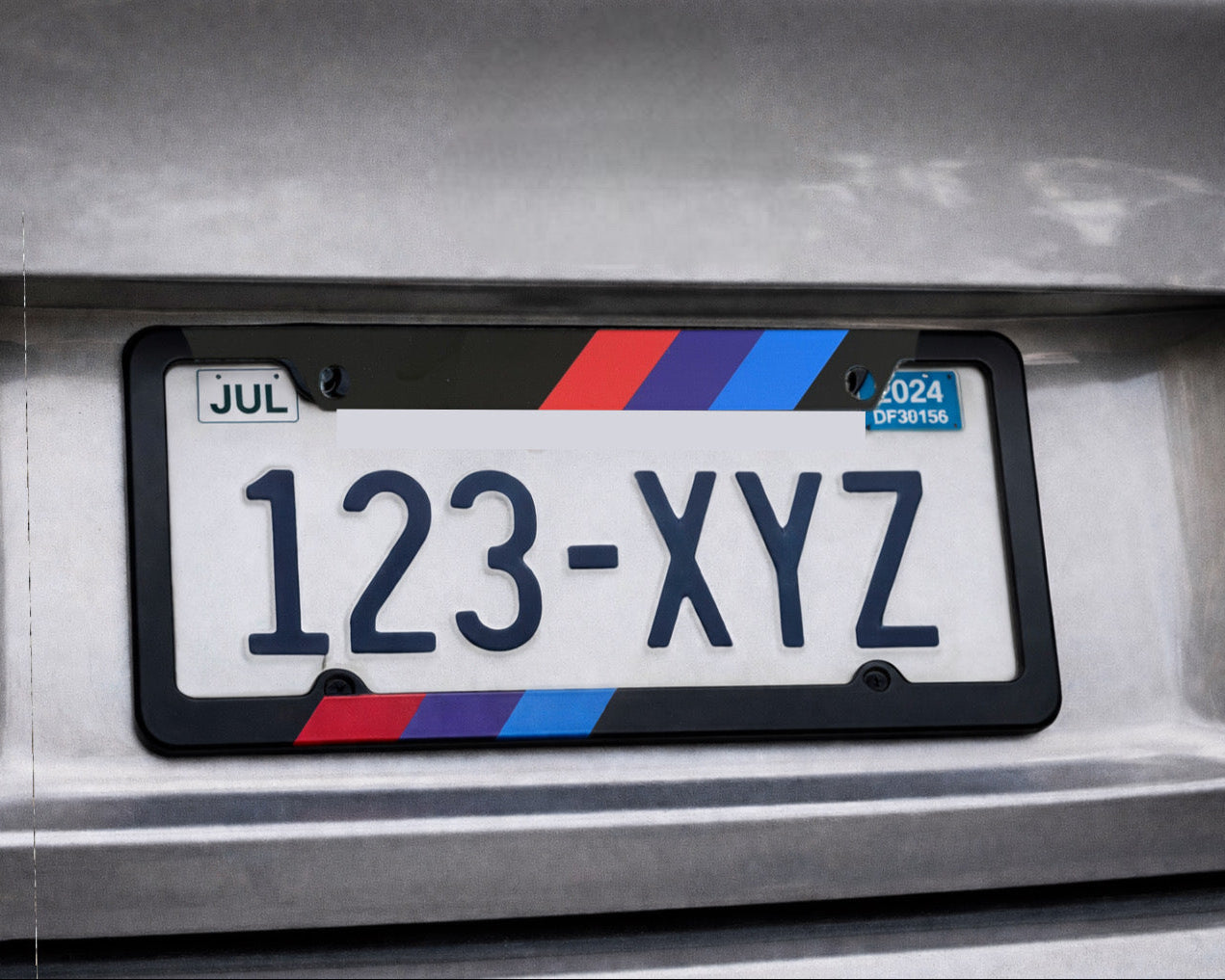 Car license plate with a black frame on a vehicle's back